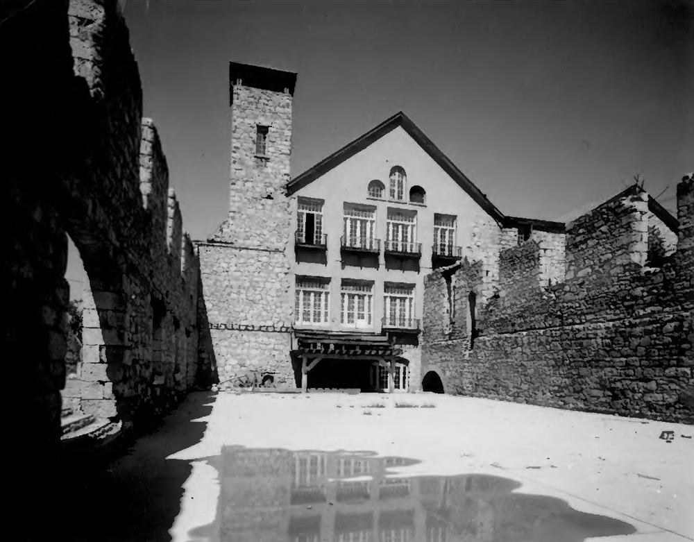 Historic interior courtyard of the Granite Paper Mill with chimney and multi-story facade